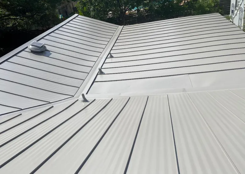 Solar attic fan installed on a metal roof for Roof Ventilation in Harrisonville